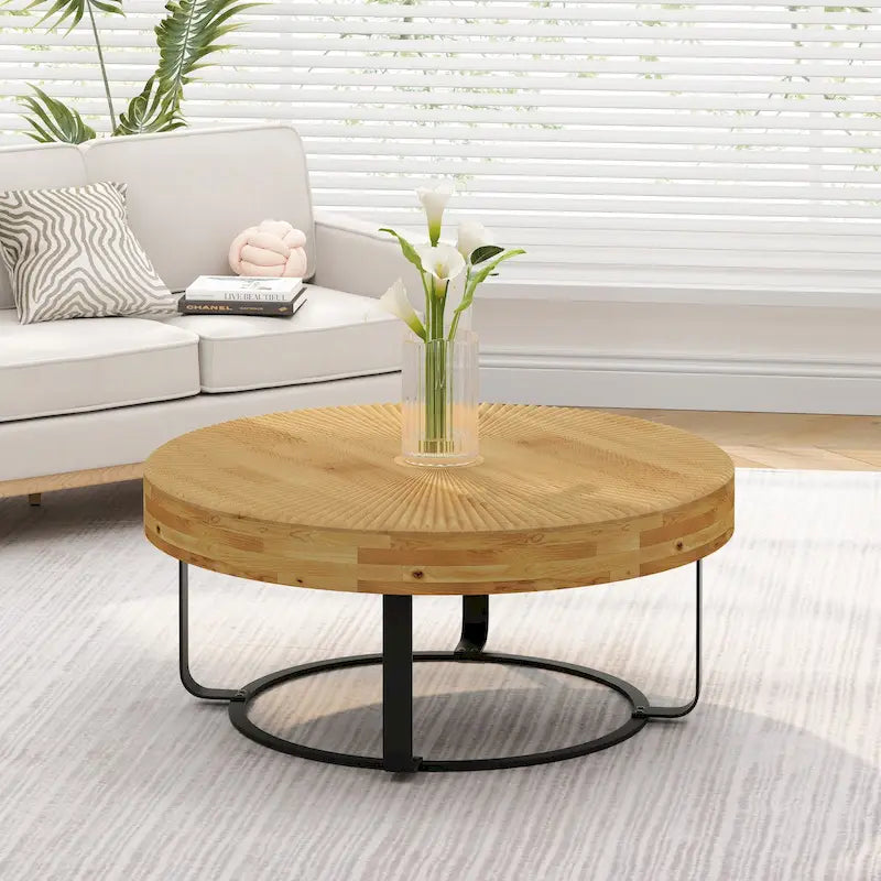 Table basse ronde naturelle et noire, plateau en bois sculpté, piètement en métal à 6 pieds